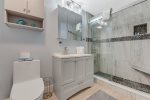 Updated bathroom with glass enclosed tile shower and shower tower for maximum luxury